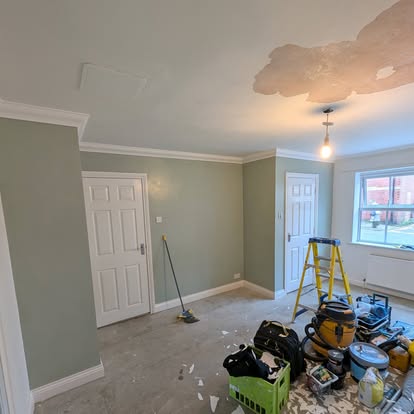 Sage green interior with white trim during painting renovation