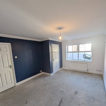 Room with navy accent wall and white trim